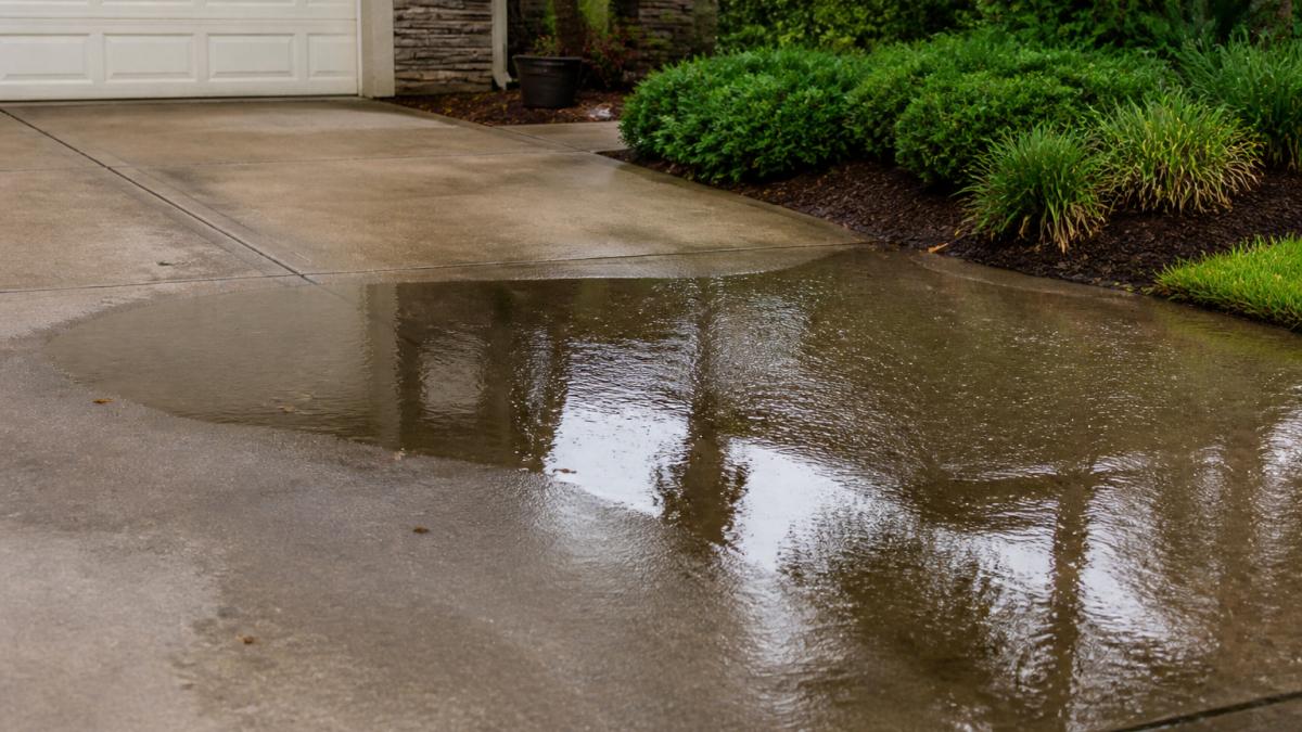 Prevent Driveway Flooding: A Rainy Season Guide 2 Diagram identifying low spots where water pools to help prevent driveway flooding after heavy rain.
